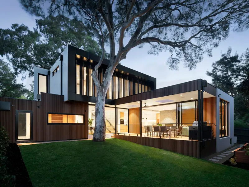 Well-kept home with a healthy, freshly cut green lawn at dusk