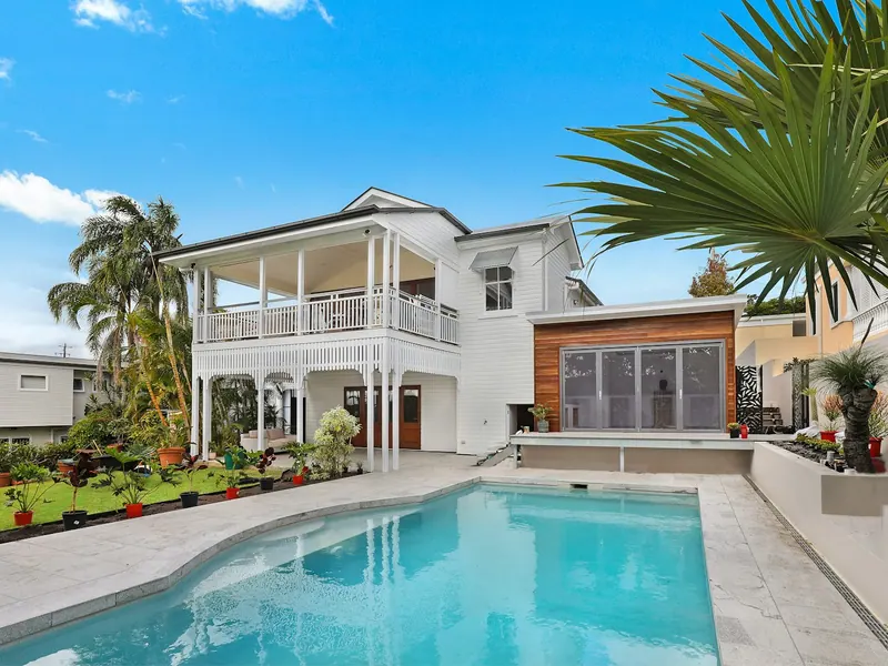 Clean patio and pool deck beside a freshly washed home exterior